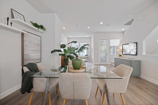 dining space with light hardwood / wood-style flooring