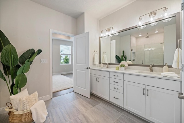 bathroom featuring a shower with door and vanity