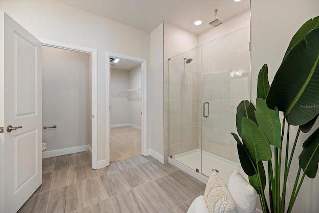 bathroom featuring toilet and walk in shower