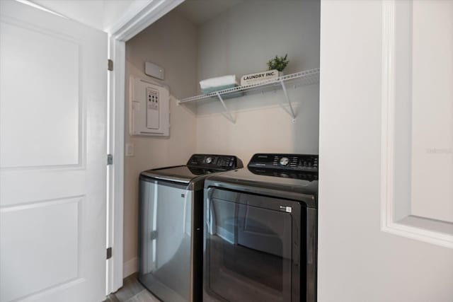 washroom with separate washer and dryer and electric panel