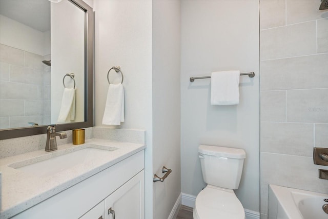 full bathroom featuring toilet, vanity, and tiled shower / bath