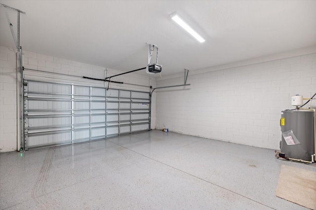 garage featuring electric water heater and a garage door opener