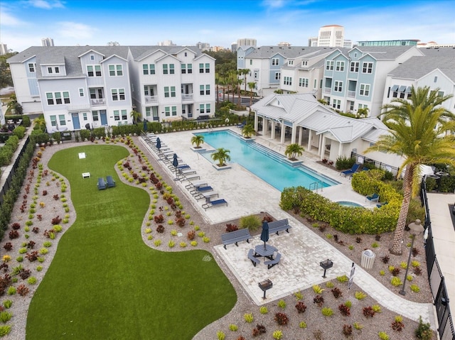 view of pool featuring a patio area and a yard