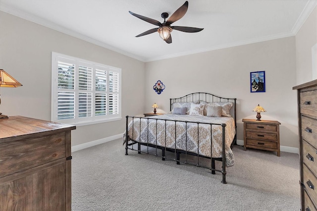 bedroom with ceiling fan, light colored carpet, and crown molding