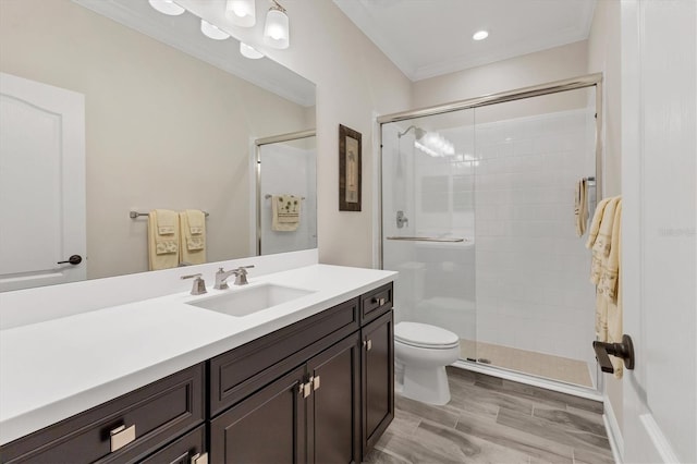 bathroom with a shower with shower door, vanity, and ornamental molding