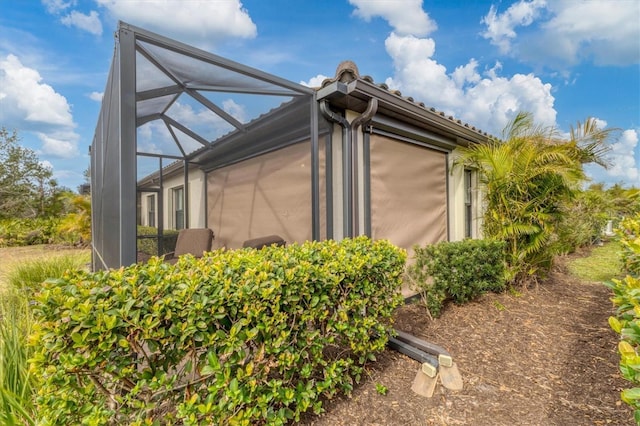 view of side of home featuring a lanai