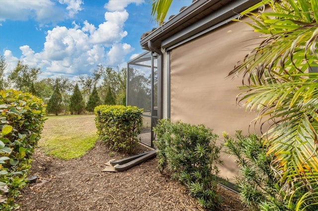 view of side of property with a lanai