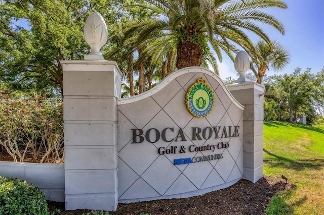 community / neighborhood sign featuring a lawn