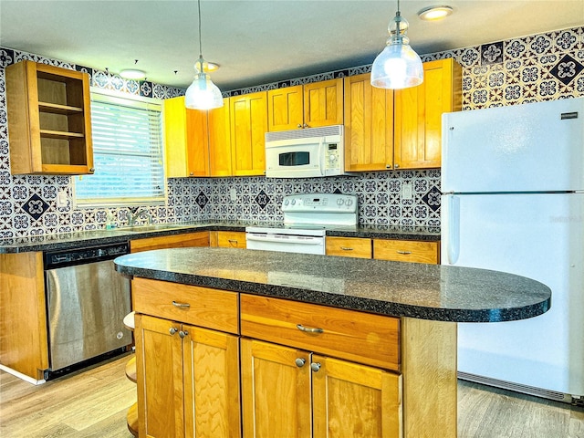 kitchen with white appliances, light hardwood / wood-style floors, and decorative backsplash