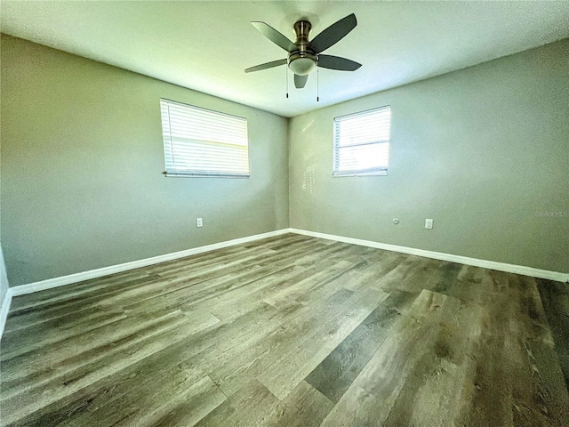 spare room with hardwood / wood-style floors and ceiling fan