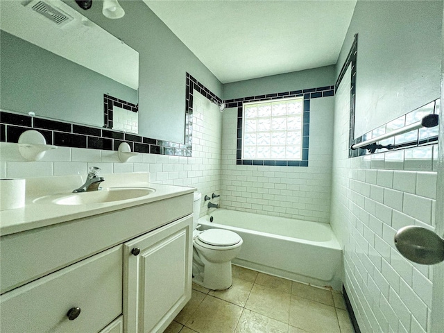 full bathroom featuring vanity, tile walls, tile patterned floors, and toilet