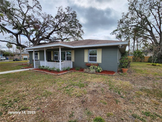 ranch-style house with covered porch and a front yard