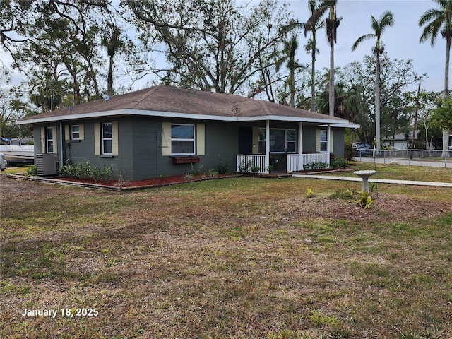 single story home with a front yard, covered porch, and central air condition unit