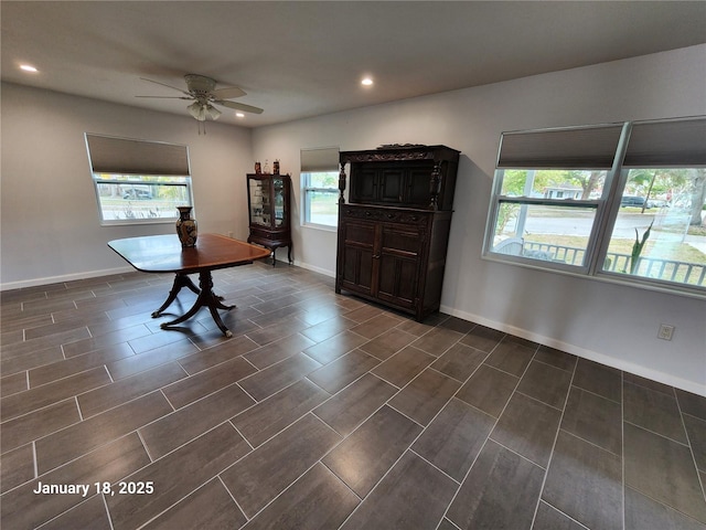 interior space with ceiling fan