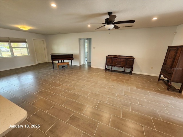 interior space with ceiling fan