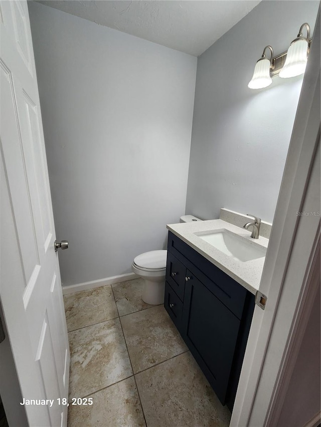 bathroom with toilet and vanity