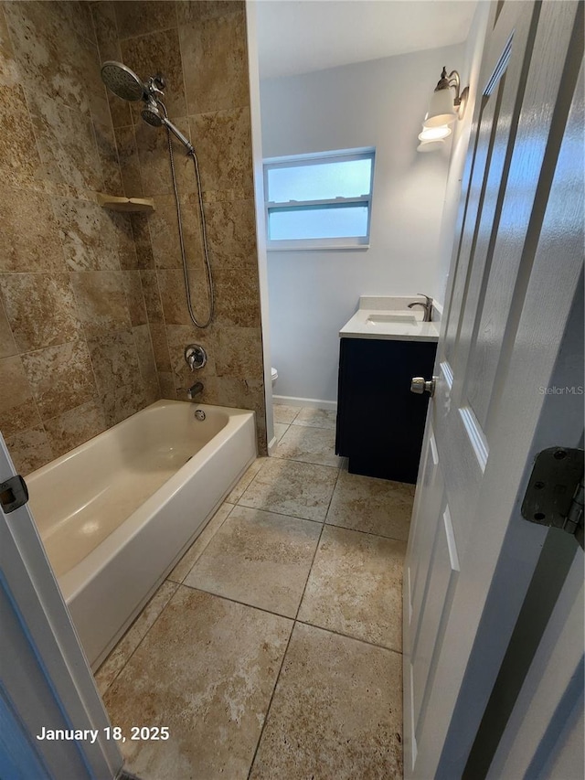 full bathroom with toilet, vanity, tiled shower / bath combo, and tile patterned floors