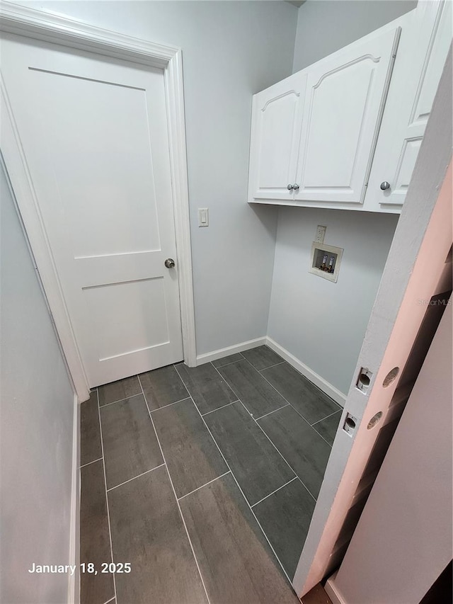 laundry area featuring washer hookup and cabinets