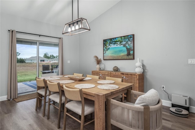 dining room with vaulted ceiling and hardwood / wood-style floors