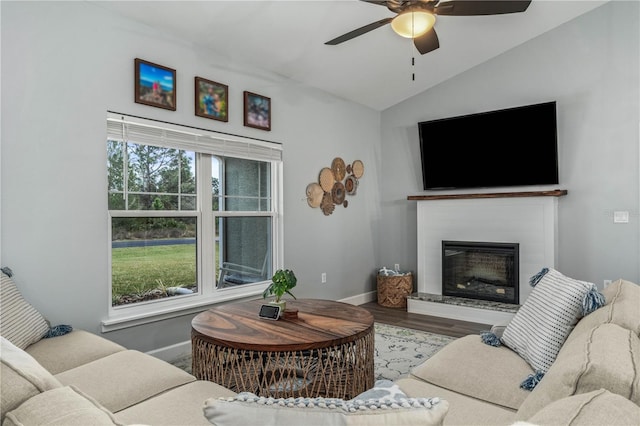 living room with vaulted ceiling, ceiling fan, a wealth of natural light, and wood-type flooring