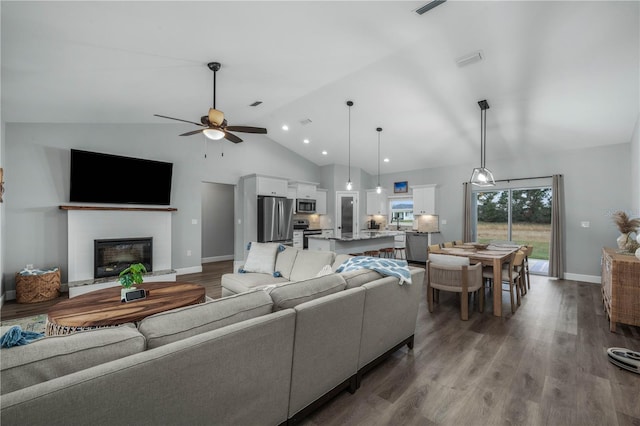 living room featuring ceiling fan, wood-type flooring, and high vaulted ceiling