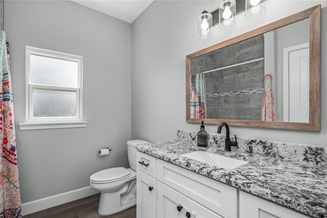 bathroom featuring hardwood / wood-style floors, toilet, and vanity