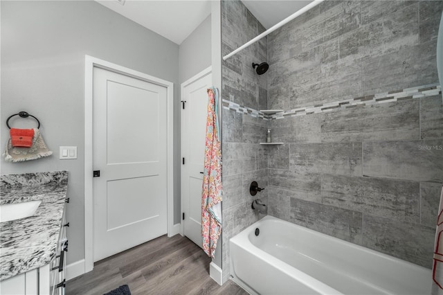 bathroom featuring shower / bathtub combination with curtain, hardwood / wood-style floors, and vanity