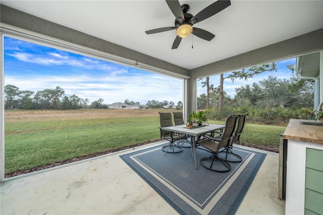 view of patio / terrace featuring ceiling fan and a rural view