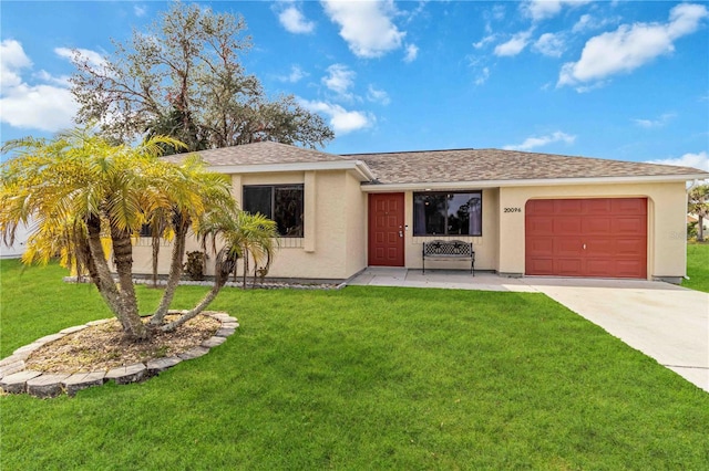 view of front of house featuring a front yard and a garage