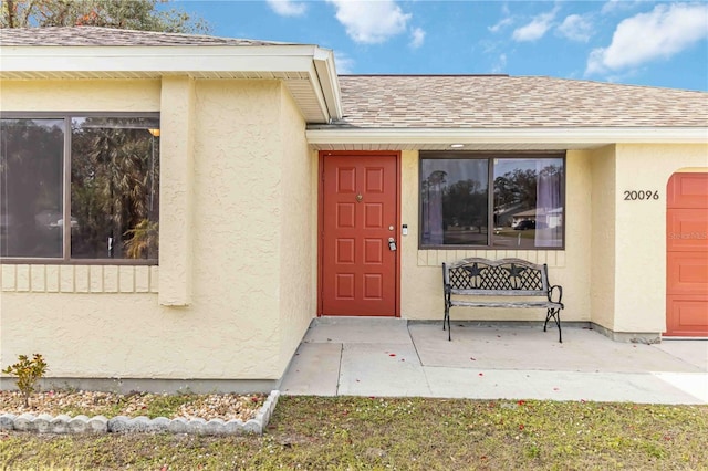 view of exterior entry with a garage