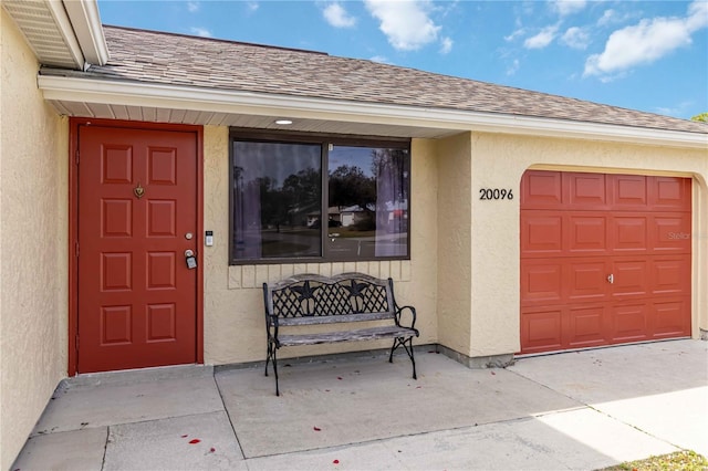 view of exterior entry featuring a garage