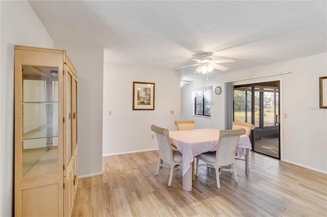 dining area featuring ceiling fan, a textured ceiling, and light hardwood / wood-style flooring