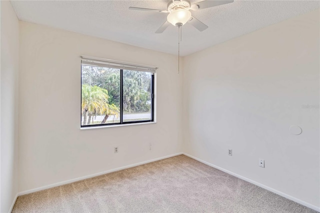 spare room with ceiling fan and carpet flooring