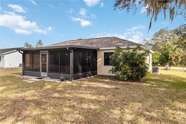 back of house with a yard, a sunroom, and central AC