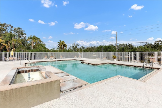 view of pool with a patio area and a jacuzzi