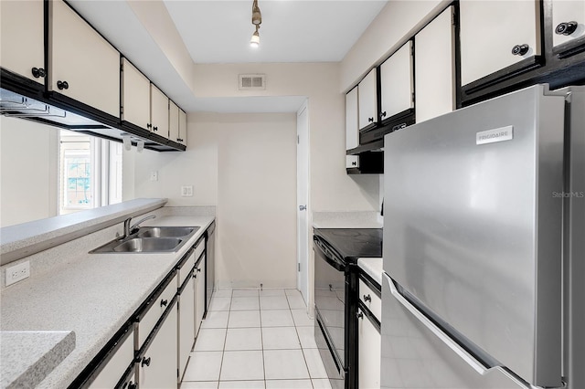 kitchen with black appliances, track lighting, sink, and white cabinetry