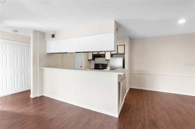 kitchen with white cabinets, black electric range oven, refrigerator, and kitchen peninsula