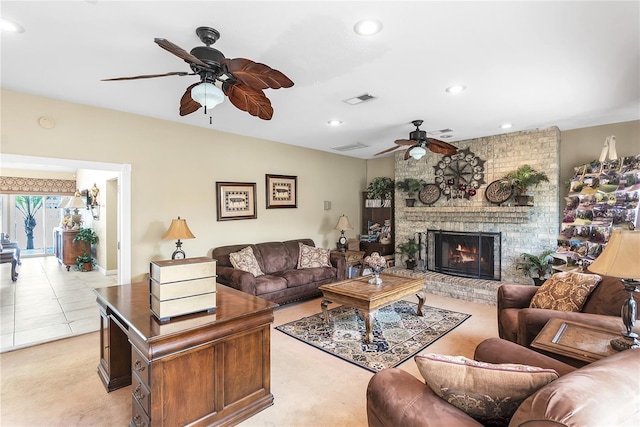 living room with a brick fireplace and light tile patterned floors