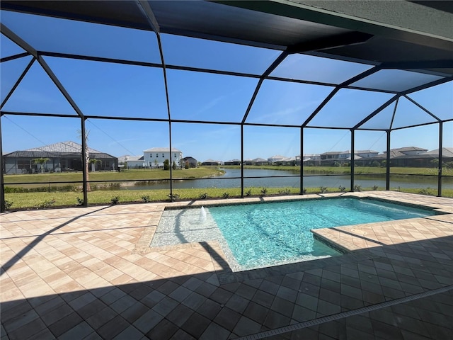 view of pool featuring a patio area, a water view, and glass enclosure