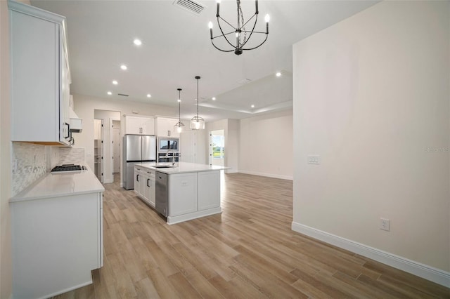 kitchen featuring stainless steel appliances, baseboards, recessed lighting, an inviting chandelier, and light wood-style floors