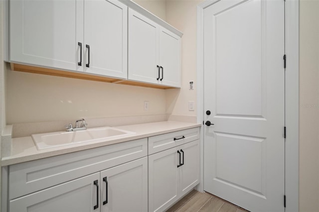 washroom with a sink and light wood-style floors