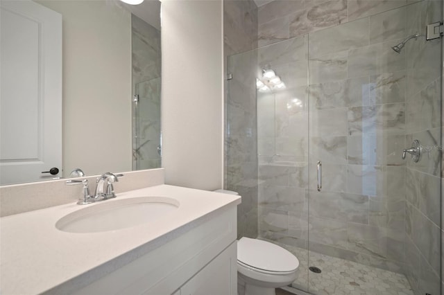 full bathroom with vanity, toilet, and a stall shower