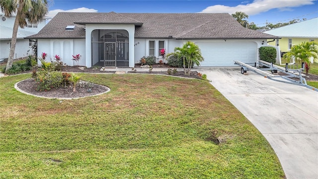 ranch-style home with a front lawn and a garage