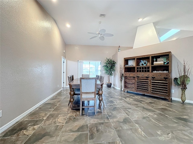 dining space featuring ceiling fan and high vaulted ceiling