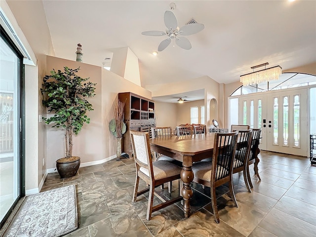 dining area with ceiling fan with notable chandelier