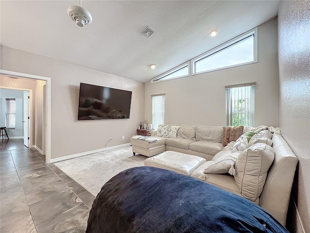 living room featuring a textured ceiling and lofted ceiling