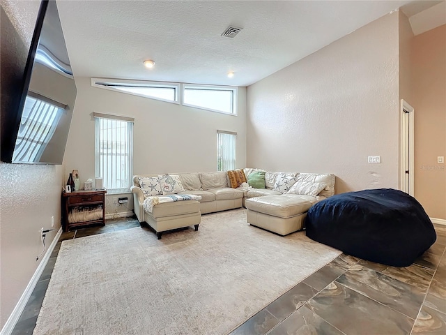 living room featuring a textured ceiling and lofted ceiling