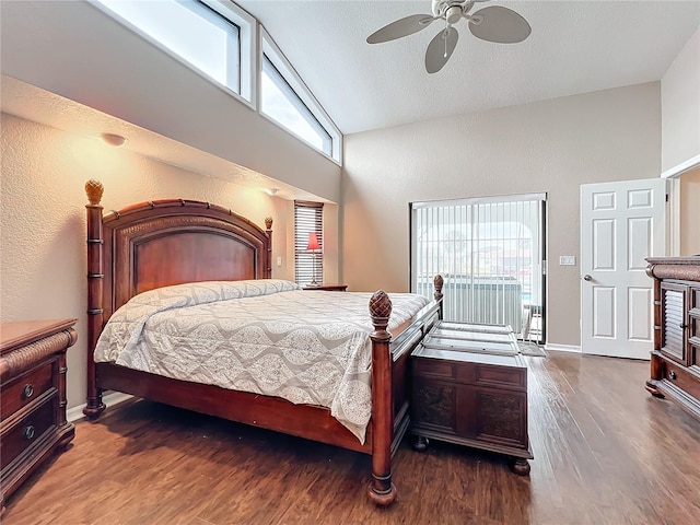 bedroom with ceiling fan, dark wood-type flooring, and high vaulted ceiling