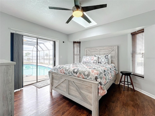 bedroom featuring ceiling fan, access to exterior, dark hardwood / wood-style floors, and multiple windows