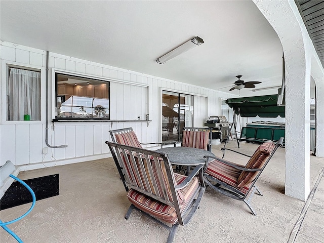 view of patio / terrace featuring ceiling fan, a hot tub, and a grill